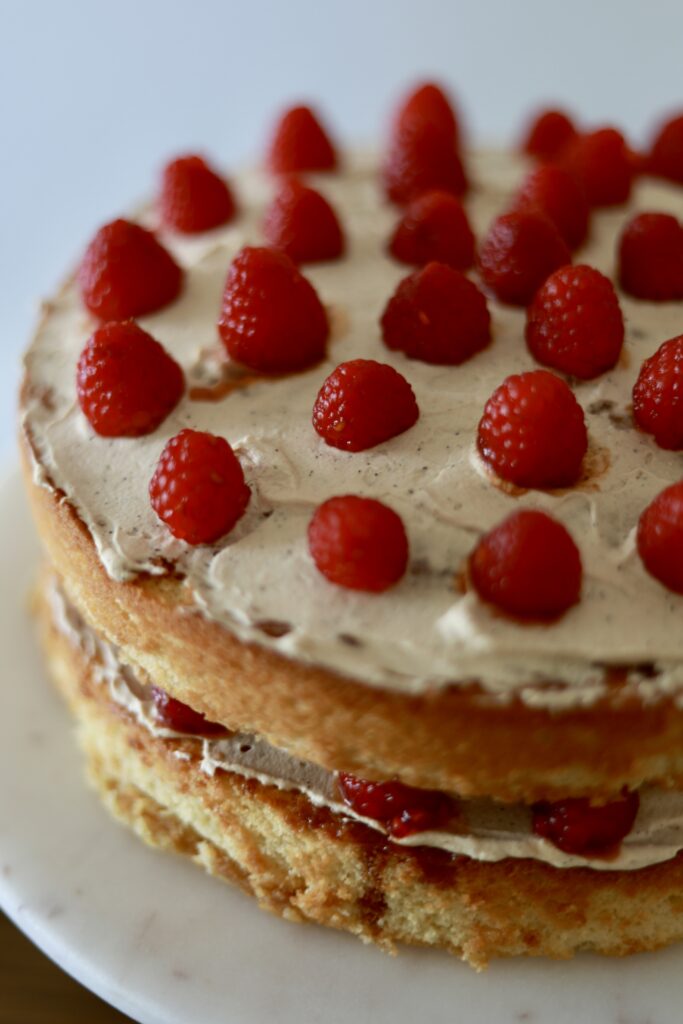 yellow cake with raspberries on top